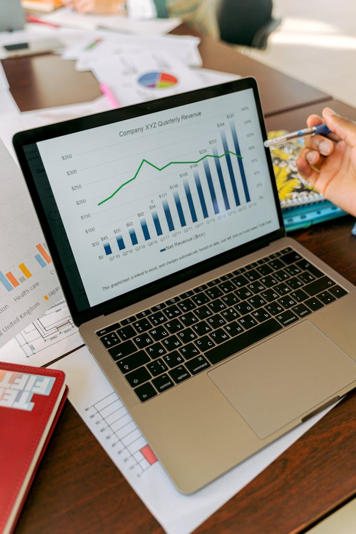 who-we-are A close-up view of a laptop displaying business analytics and revenue charts.